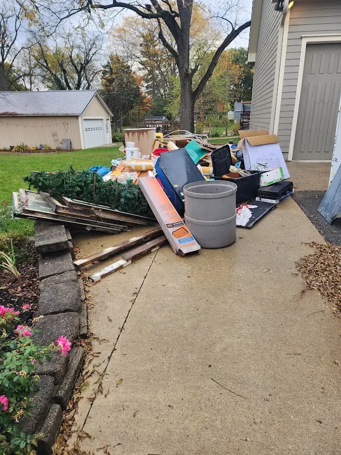Dumpster being loaded with debris for 12 Yard Dumpster Rental in Batesville